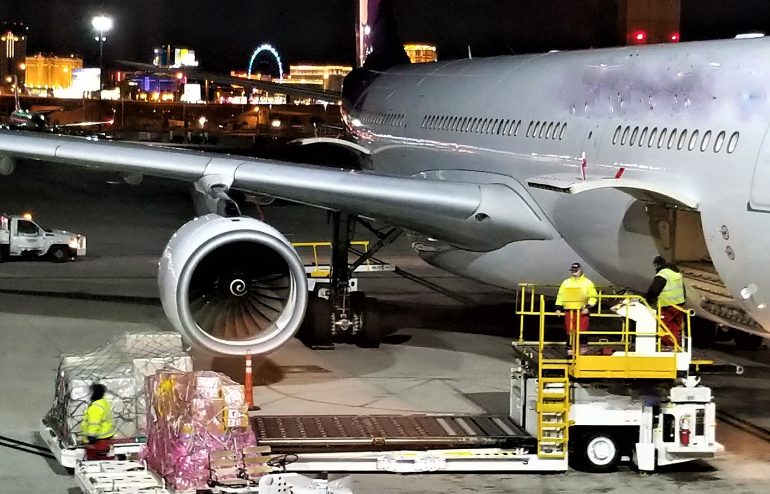 Luggage being loaded onto a large airplane with Determining Air Freight Rates